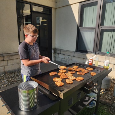 Volunteers of all ages help cook!
