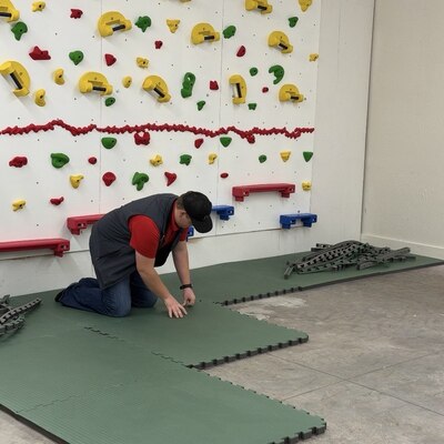 Putting down the gym floor - Thank you to our match day donors the floor was purchased last year