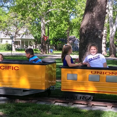 Children riding in wheelchair accessible train car promoted by 3Rivers staff and volunteers.