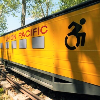 Side view of Wamego City Park's accessible train car which displays the accessibility symbol